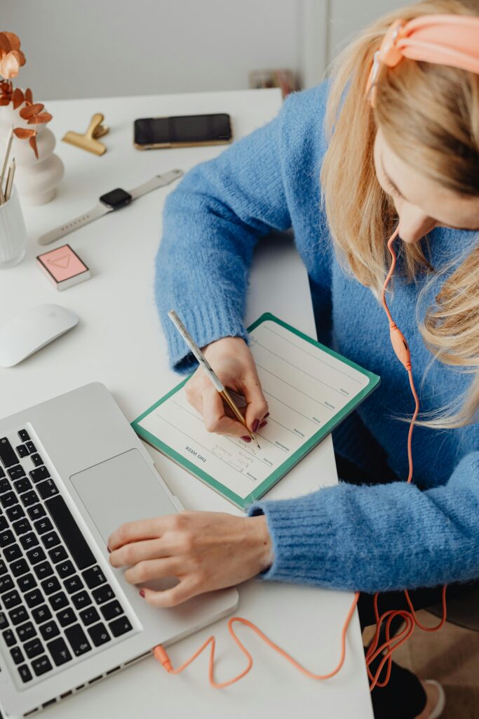 A woman writing and checking information. 